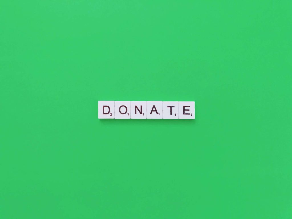 Donate word on green table