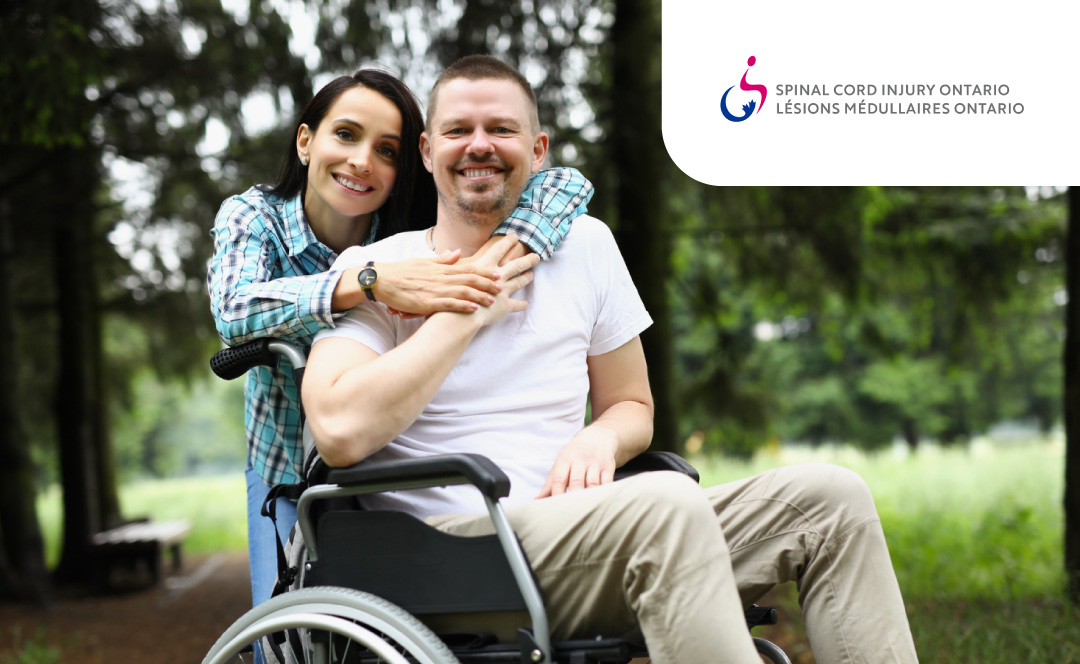A couple is hugging, smiling, and looking to the camera. The husband is on a wheelchair. The logo of Spinal Cord Injury Ontario is on the corner.