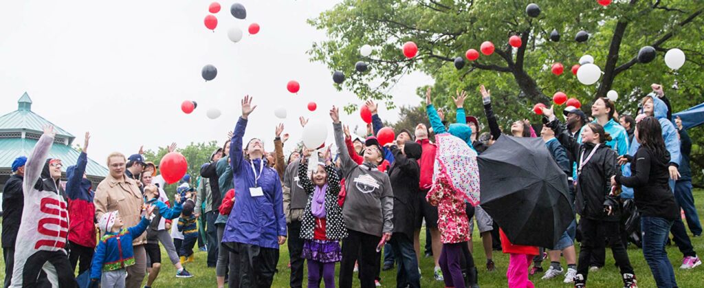 happy people leaving balloons in the air