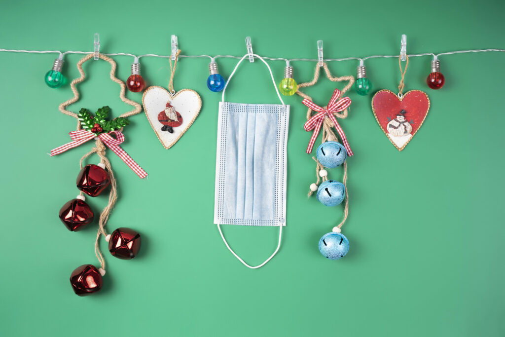 Christmas decorations in a garland of colored lights and medical mask