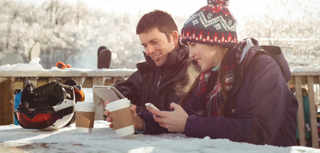 Two young adults checking their New Year's resolutions list in a winter environment