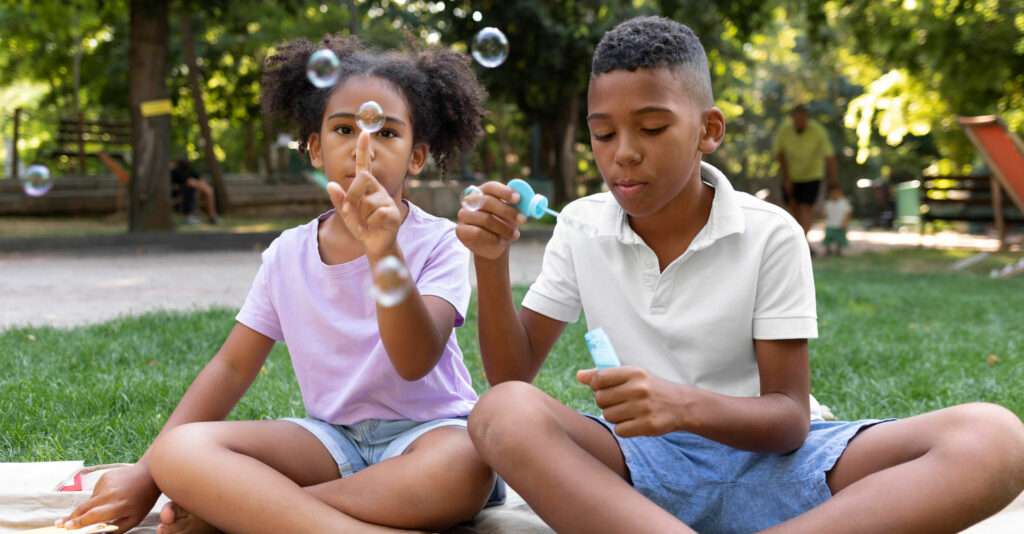 Two black kids playing together in the park