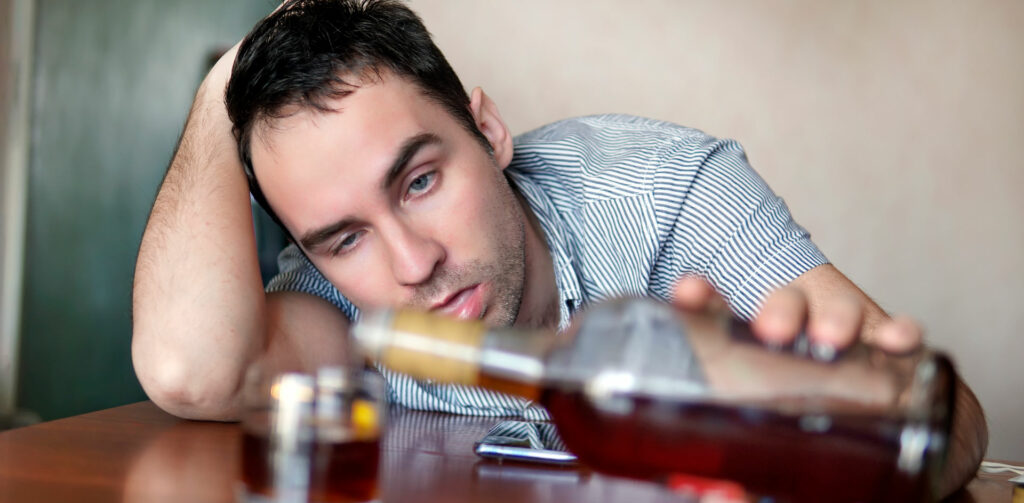 Alcohol and Health Header image Person notably affected by alcohol serving more in his glass