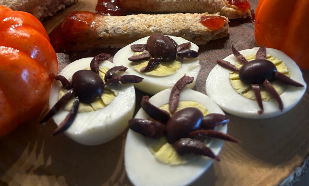 Parents preparing Halloween themed dinner for family
